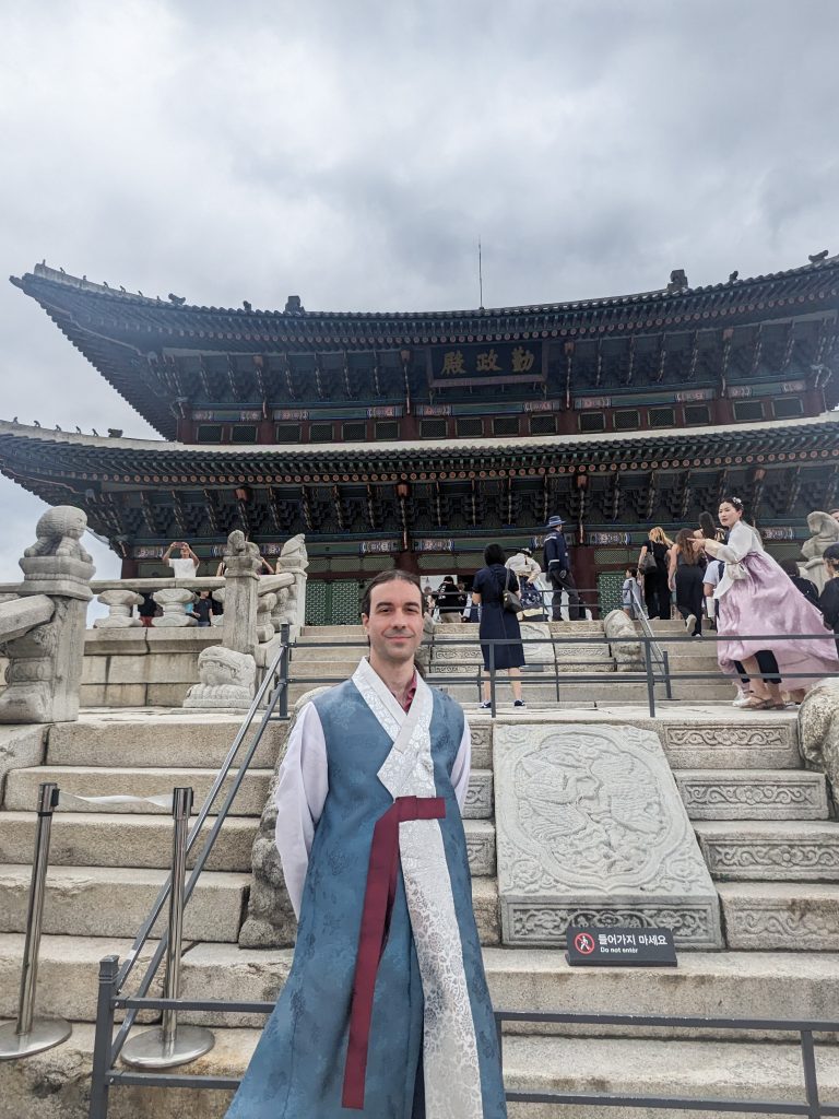 Photo of a professor in front of a Korean palace