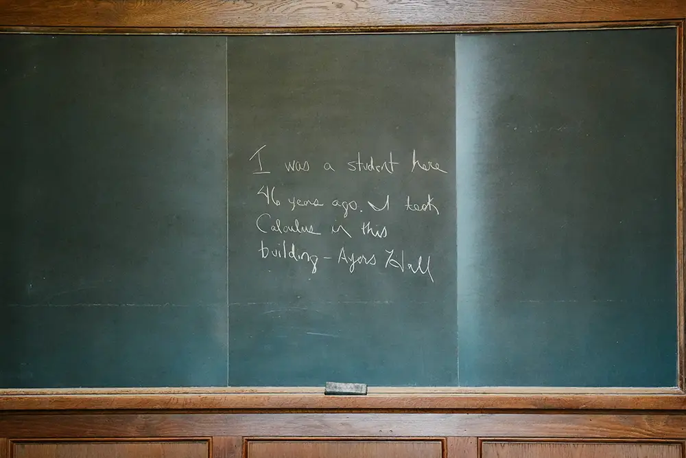 Chalkboard photo with “I was a student here 46 years ago. I took calculus in this building –Ayres Hall” written on it.