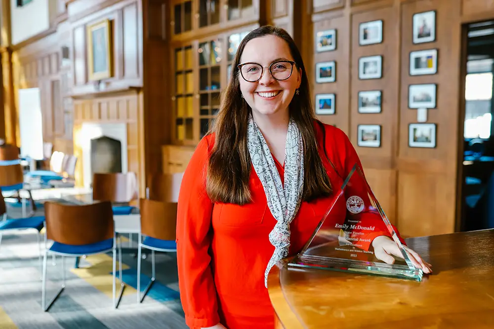 Emily McDonald holds her Presidential Award for Excellence in Mathematics and Science Teaching.
